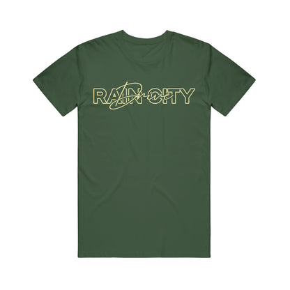 Dark green Rain City Drive T-shirt featuring RAPCITY in bold yellow outlined letters across the chest, with a stylized yellow swoosh and cityscape graphic.