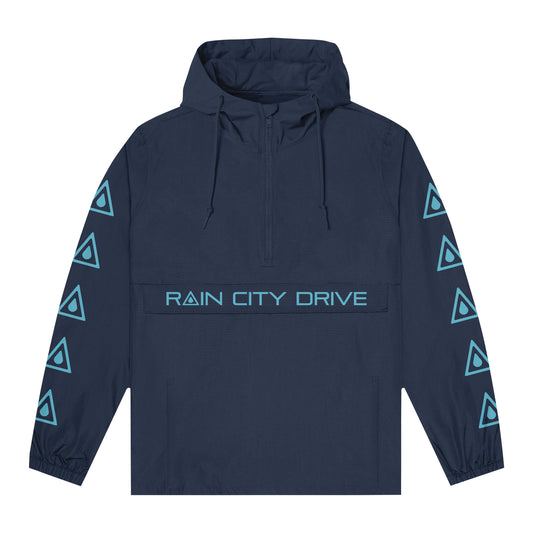 A navy blue Rain City Drive nylon anorak jacket featuring light blue triangle sleeve patterns, "RAIN CITY DRIVE" on the front pocket, a front zipper, and elastic cuffs—ideal for any men’s jacket collection.